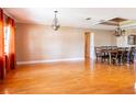 Spacious living room featuring hardwood floors, elegant chandelier, and decorative ceiling trim at 4209 Forrestal Ave, Orlando, FL 32806