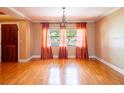 Bright living room with hardwood floors, large windows, and decorative curtains at 4209 Forrestal Ave, Orlando, FL 32806
