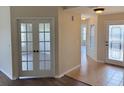 Inviting foyer features tiled flooring, glass paneled front door, and decorative french doors at 17430 Se 110Th Ter, Summerfield, FL 34491