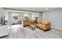 Spacious living room featuring two comfortable sofas, light gray walls, and light wood flooring at 2508 Yale Ave, Sanford, FL 32773
