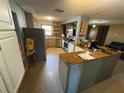 Kitchen featuring a refrigerator, and lots of cabinets and counterspace with a breakfast bar area at 1818 Mango Tree Dr, Edgewater, FL 32132