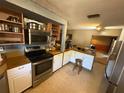 Functional kitchen with stainless steel appliances, wooden countertops, and ample storage cabinets at 1818 Mango Tree Dr, Edgewater, FL 32132