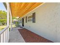 Inviting front porch with a wood ceiling, offering a glimpse of the home's exterior details at 219 Vermont Ave, St Cloud, FL 34769