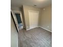 Cozy carpeted bedroom with a double door closet, neutral walls and baseboard trim at 24202 Nw Aspen Ln, Dunnellon, FL 34432