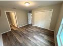 Primary bedroom featuring wood-look flooring, neutral walls, walk in closet, and ensuite bathroom at 24202 Nw Aspen Ln, Dunnellon, FL 34432