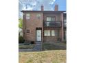Brick condo with a small balcony and an unfinished front yard at 5032 Downing St # 10, Orlando, FL 32839