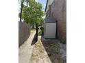 A backyard shed next to a townhome behind a wood fence at 5032 Downing St # 10, Orlando, FL 32839