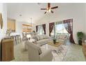 Sun-drenched living room showcasing tile floors, vaulted ceilings, and sliding glass doors for seamless indoor-outdoor flow at 777 Summit Greens Blvd, Clermont, FL 34711