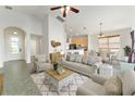 Bright and open living room with tile floors, neutral furniture, and vaulted ceilings offers a cozy atmosphere at 777 Summit Greens Blvd, Clermont, FL 34711