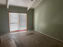 Bedroom with a sliding glass door and uncarpeted floors, with painted green walls and a white ceiling at 116 Wild Holly Ln, Longwood, FL 32779