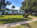 Green building exterior with well-maintained landscaping and sidewalk access at 535 Midway Dr # A, Ocala, FL 34472
