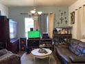 Cozy living room with vintage furniture, textured walls, and decor; a comfortable and lived-in space at 705 Grape Ave, St Cloud, FL 34769