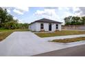 Freshly painted single-story home with a new driveway, modern roof and landscaping at 991 Polk St, Bartow, FL 33830