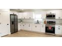New kitchen with stainless appliances, white cabinets and quartz countertops at 991 Polk St, Bartow, FL 33830