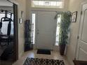 Inviting entryway with neutral tones and a decorative plant adds a welcoming touch to this home at 31517 Broadwater Ave, Leesburg, FL 34748