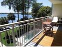 Balcony view overlooks pool and lush landscaping with lake views beyond at 690 Osceola Ave # 405, Winter Park, FL 32789