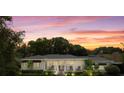 Charming home featuring a landscaped front yard, covered porch and a circular driveway at 1410 Poinsettia Ave, Orlando, FL 32804