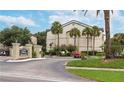 Community entrance sign with lush landscaping and a winding driveway at 1948 Lake Atriums Cir # 132, Orlando, FL 32839