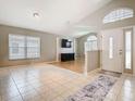 Bright and spacious living room featuring tile and hardwood floors, large windows and modern decor at 2641 Delcrest Dr, Orlando, FL 32817