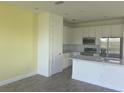 Bright kitchen with white cabinets, stainless steel appliances, and a gray countertop at 3069 Caribbean Soul Dr, Kissimmee, FL 34747