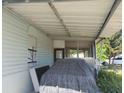 Exterior view of the home, showcasing a covered area and window at 6971 Pompeii Rd, Orlando, FL 32822