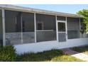 Screened-in front porch with views of the surrounding landscape and space for seating at 6971 Pompeii Rd, Orlando, FL 32822