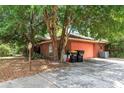 Driveway of brick home leading to side-entry garage, surrounded by trees at 418 W Holly Dr, Orange City, FL 32763