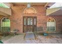 Front entrance with brick facade, decorative windows and bench seating at 418 W Holly Dr, Orange City, FL 32763