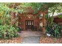 Covered front porch featuring brick columns and a seating area at 418 W Holly Dr, Orange City, FL 32763