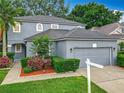 Attractive gray two-story home boasting well-kept landscaping and an attached two-car garage at 9525 Southern Garden Cir, Altamonte Springs, FL 32714