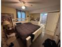 Comfortable bedroom with tiled floors, a ceiling fan and natural light at 2094 Penn Dr, Deland, FL 32724