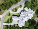 Overhead shot showcases the home's unique roofline and sprawling layout, complemented by verdant landscaping at 8707 Nw 31St Lane Rd, Ocala, FL 34482