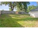 Expansive backyard featuring a wooden fence, mature trees, and ample green space for recreation at 294 Lake Doe Blvd, Apopka, FL 32703