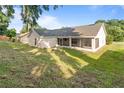 Spacious backyard featuring a screened-in lanai, mature trees, and ample space for outdoor activities at 294 Lake Doe Blvd, Apopka, FL 32703