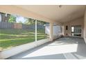 Enclosed lanai offering a relaxing space with views of the backyard, perfect for entertaining or unwinding at 294 Lake Doe Blvd, Apopka, FL 32703