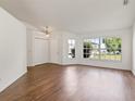 Bright living room features hardwood floors, large windows and plenty of natural light, with white walls at 294 Lake Doe Blvd, Apopka, FL 32703