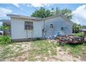 Backyard view of house with lawn at 7043 Curtis Ave, Groveland, FL 34736