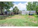 Backyard view of house with lawn and shed at 7043 Curtis Ave, Groveland, FL 34736