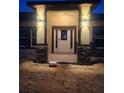 Inviting front entrance with decorative stone pillars and sconce lighting at 13074 Sw 104Th Ln, Dunnellon, FL 34432