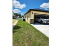 Attached two-car garage with a white pickup truck parked inside, and stone accents on the exterior at 13074 Sw 104Th Ln, Dunnellon, FL 34432
