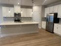 Spacious kitchen featuring white cabinets, quartz countertops, and stainless steel appliances at 1710 Summer Rose Dr, Mount Dora, FL 32757