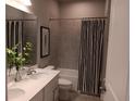 Beautifully designed bathroom featuring a double vanity, tiled walls, and a shower-tub combination at 742 Copper Creek Dr, New Smyrna Beach, FL 32168