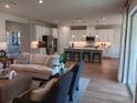 Elegant open-concept living space with hardwood flooring, a modern kitchen and stylish decor at 742 Copper Creek Dr, New Smyrna Beach, FL 32168