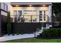 Outdoor patio with chairs and spiral staircase that leads to upper floors and manicured garden at 1841 Moorings Ct, Clermont, FL 34711