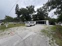 View of front exterior featuring gravel driveway and white exterior at 721 Crestview Dr, Casselberry, FL 32707