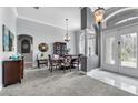 Elegant dining room with stylish lighting, neutral color palette, and ornate furnishing at 4013 Greystone Dr, Clermont, FL 34711