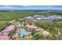 Expansive aerial view showcasing condos with a resort-style pool area and manicured landscaping at 8601 Worldquest Blvd # 3404, Orlando, FL 32821