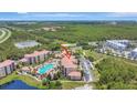 Picturesque aerial view of the condos featuring a large community pool and well-maintained grounds at 8601 Worldquest Blvd # 3404, Orlando, FL 32821