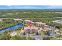 Sprawling aerial view of condos by a tranquil lake with lush greenery and beautiful surroundings at 8601 Worldquest Blvd # 3404, Orlando, FL 32821