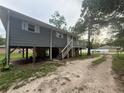 Back exterior view of a home featuring a deck and stilt foundation at 5641 Nw 55Th Ave, Ocala, FL 34482